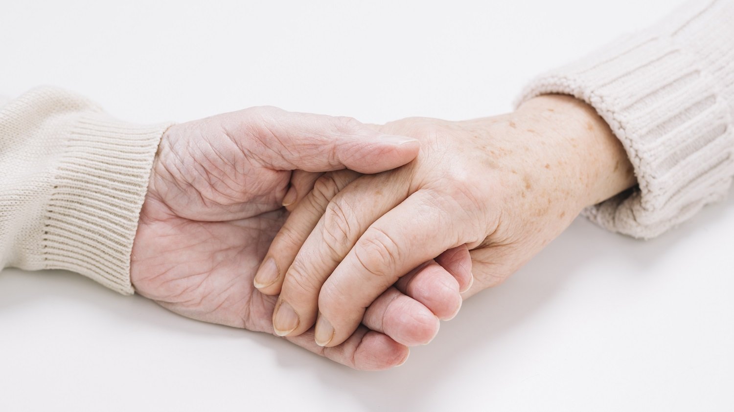 older couple holding hands Alzheimers support