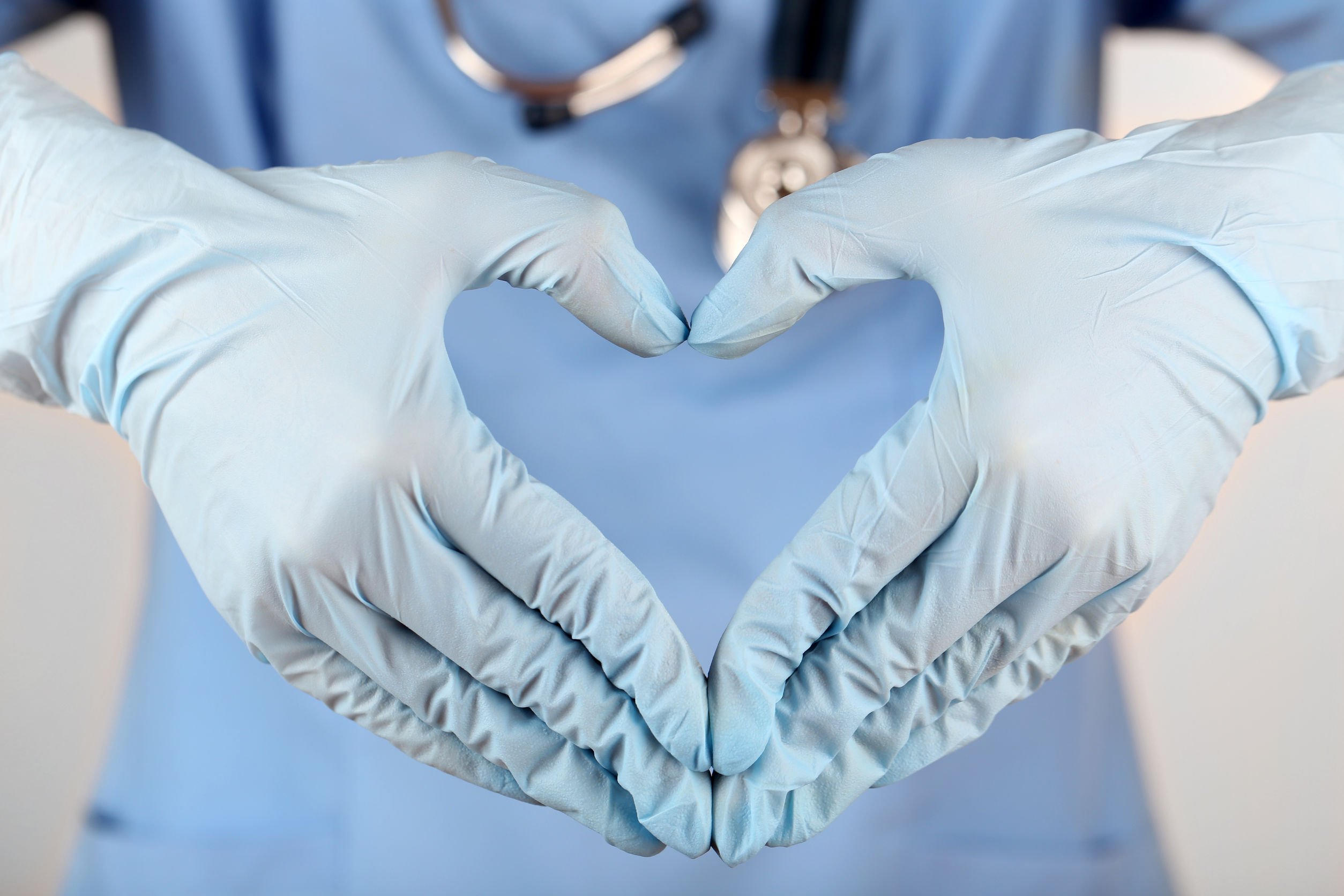 nurse making a heart with her hands